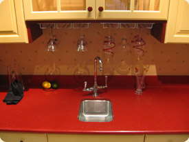 An image of a smooth, red, solid surface countertop.
